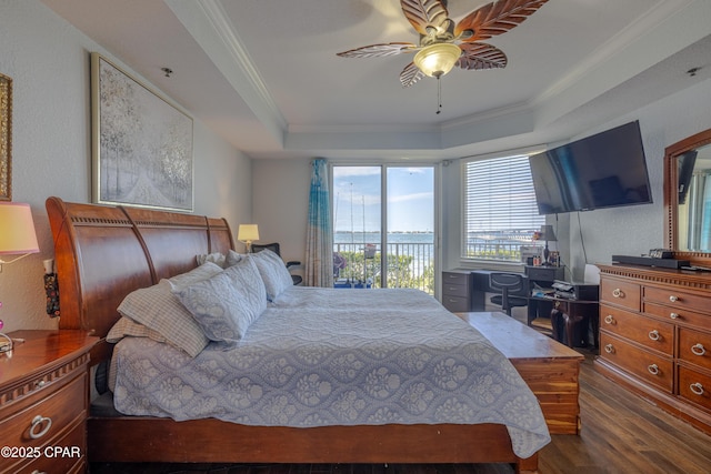 bedroom featuring wood finished floors, a raised ceiling, crown molding, access to exterior, and ceiling fan