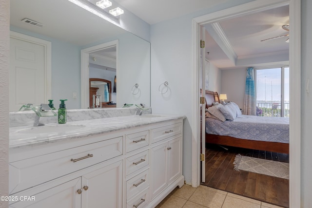 full bath featuring ensuite bath, double vanity, tile patterned floors, and crown molding