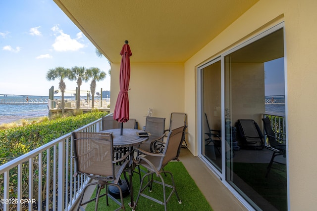 balcony with view of water and beach