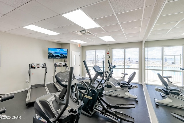 gym with a paneled ceiling