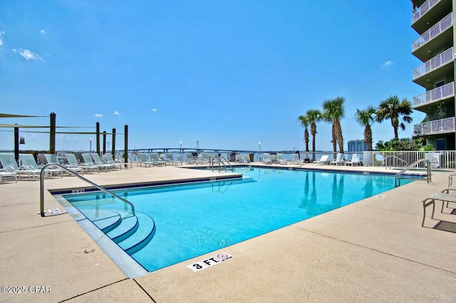 community pool featuring a patio area and fence