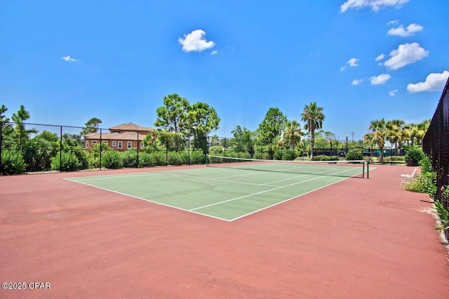 view of tennis court featuring fence and community basketball court