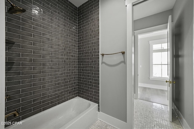 full bath featuring baseboards, washtub / shower combination, and tile patterned floors