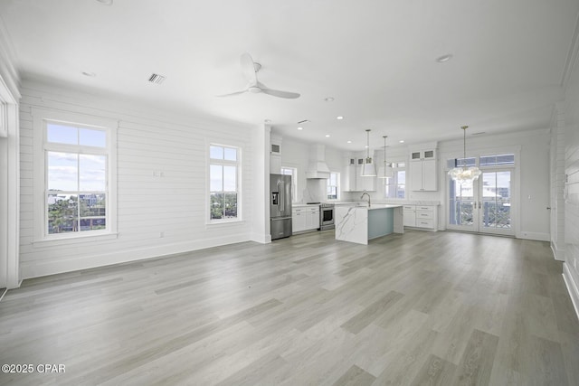 unfurnished living room featuring ceiling fan, recessed lighting, baseboards, light wood-type flooring, and visible vents