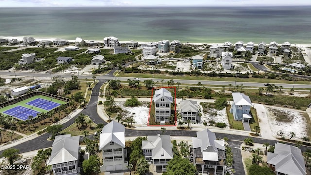 aerial view with a residential view, a view of the beach, and a water view