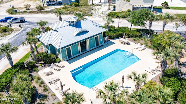 community pool featuring a patio and fence