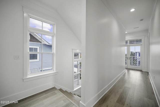 hall featuring recessed lighting, baseboards, and wood finished floors