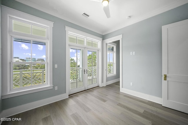 entryway with baseboards, a ceiling fan, wood finished floors, and visible vents