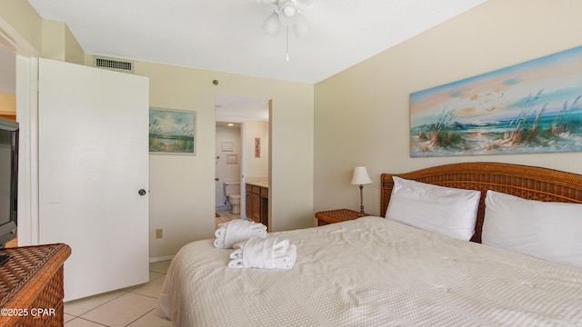 bedroom featuring light tile patterned floors, ensuite bath, and visible vents
