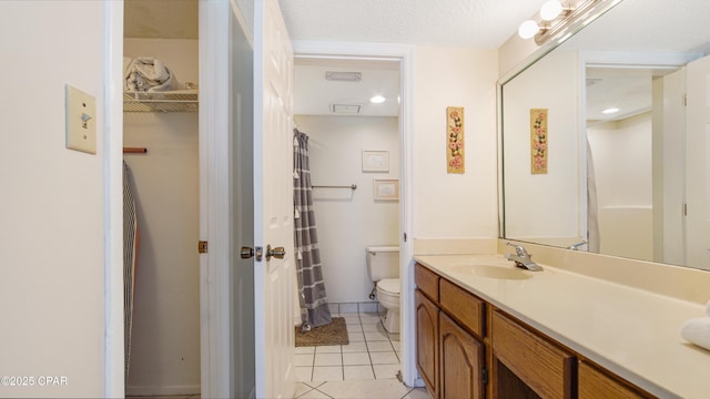 bathroom with vanity, tile patterned flooring, and toilet