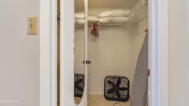 walk in closet with tile patterned floors