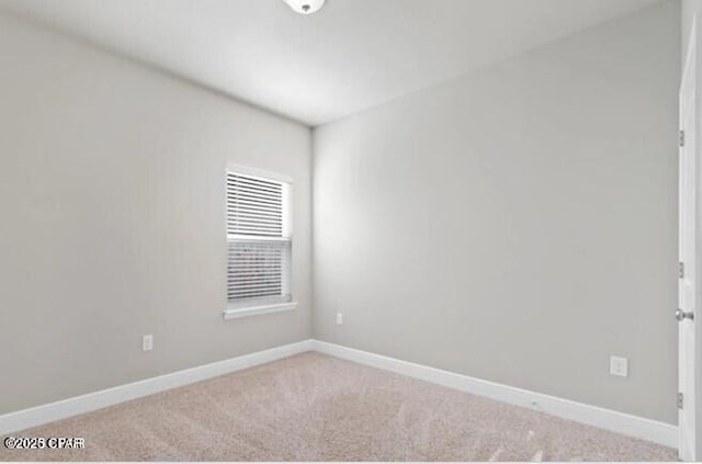 empty room with carpet floors and baseboards