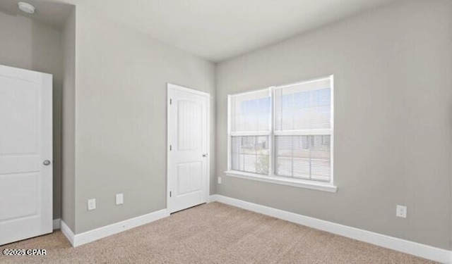 unfurnished bedroom featuring baseboards and carpet flooring