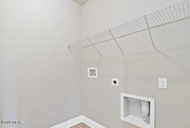 clothes washing area featuring electric dryer hookup, laundry area, baseboards, and hookup for a washing machine