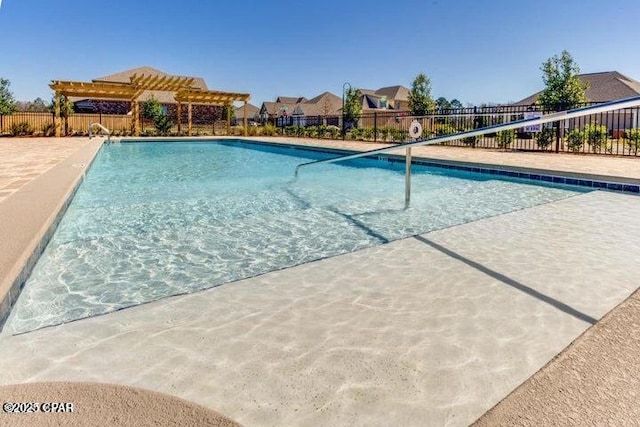 community pool with fence and a pergola