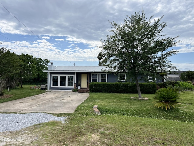 3906 W 24th Ct, Panama City, FL 32405 - ranch-style house featuring a chimney, driveway, a front yard, and metal roof