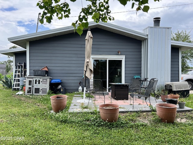 3906 W 24th Ct, Panama City, FL 32405 - back of house featuring a lawn and a patio area