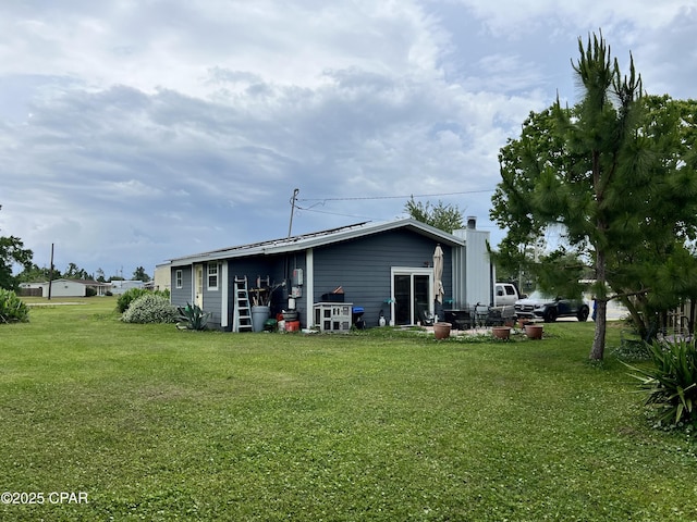 3906 W 24th Ct, Panama City, FL 32405 - exterior space featuring a lawn and a chimney