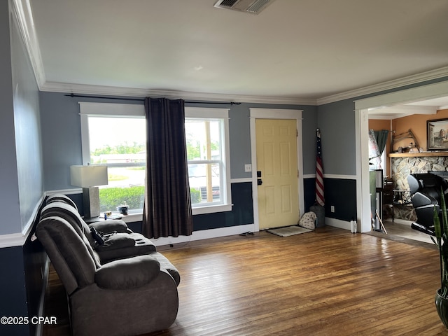 3906 W 24th Ct, Panama City, FL 32405 - living area featuring visible vents, ornamental molding, wood finished floors, a fireplace, and baseboards