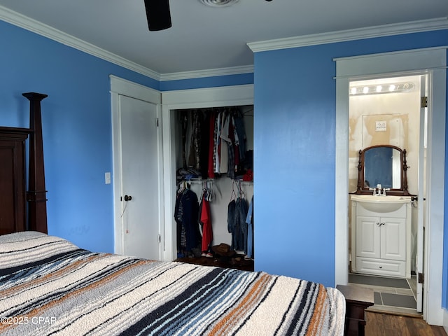 3906 W 24th Ct, Panama City, FL 32405 - bedroom featuring a closet, crown molding, visible vents, wood finished floors, and a sink