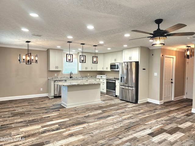 609 E Pine Forest Dr, Lynn Haven, FL 32444 - kitchen with baseboards, recessed lighting, dark wood finished floors, ceiling fan with notable chandelier, and stainless steel appliances