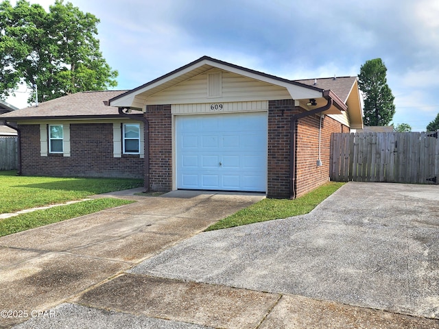 609 E Pine Forest Dr, Lynn Haven, FL 32444 - view of front of home featuring fence, an attached garage, concrete driveway, and brick siding