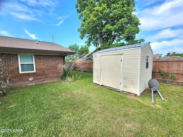 609 E Pine Forest Dr, Lynn Haven, FL 32444 - view of yard featuring a fenced backyard, a storage unit, and an outbuilding