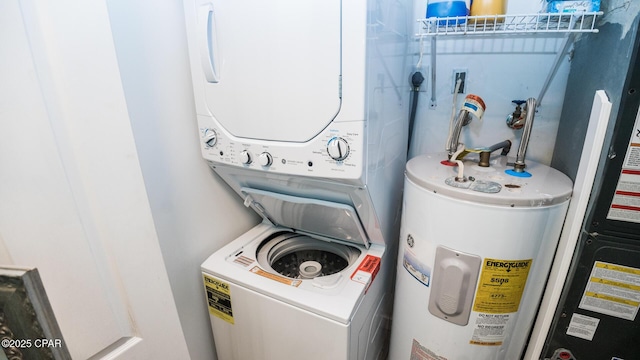 laundry area with water heater, stacked washer and clothes dryer, and electric water heater