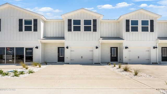 268 Salt Creek Ln, Mexico Beach, FL 32456 - modern farmhouse style home with a garage, concrete driveway, and board and batten siding