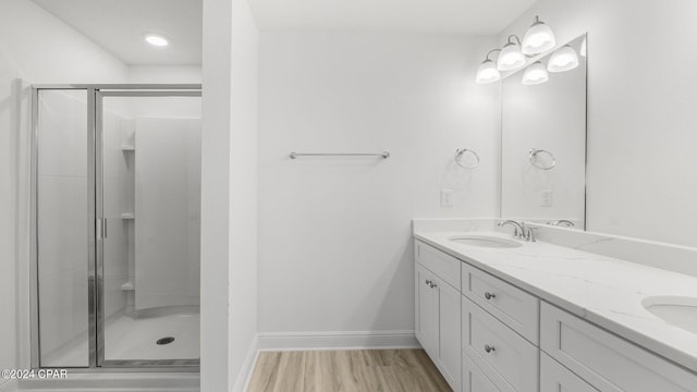 268 Salt Creek Ln, Mexico Beach, FL 32456 - full bathroom featuring a shower stall, double vanity, wood finished floors, and baseboards
