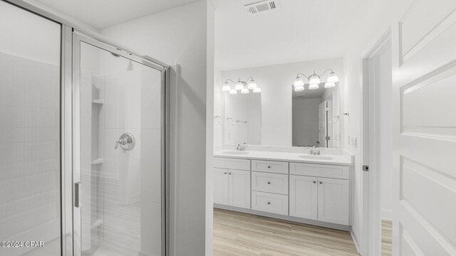 268 Salt Creek Ln, Mexico Beach, FL 32456 - full bathroom featuring a shower stall, wood finished floors, and double vanity