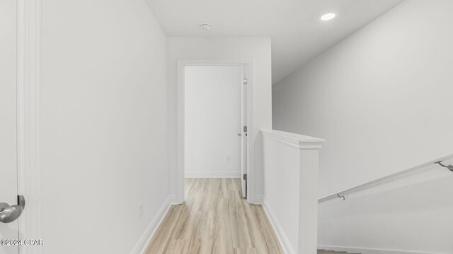268 Salt Creek Ln, Mexico Beach, FL 32456 - hallway featuring an upstairs landing, light wood-style flooring, and baseboards