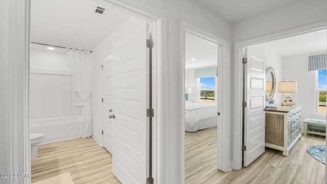 268 Salt Creek Ln, Mexico Beach, FL 32456 - ensuite bathroom featuring wood finished floors, plenty of natural light, vanity, toilet, and recessed lighting