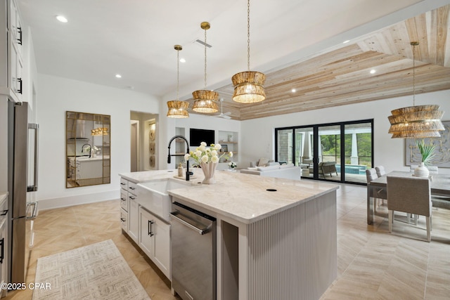 kitchen featuring a sink, stainless steel dishwasher, recessed lighting, and open floor plan