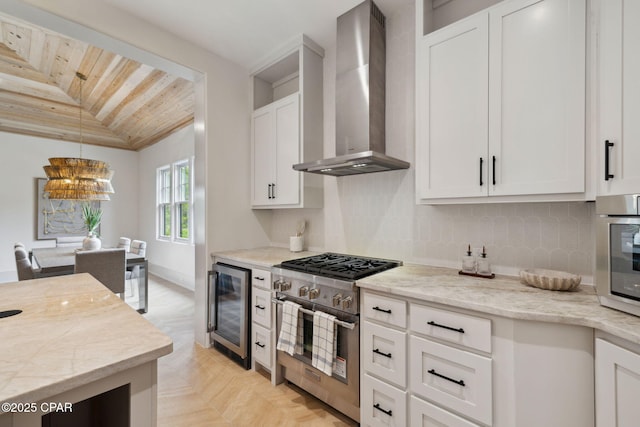 kitchen with wall chimney range hood, appliances with stainless steel finishes, wooden ceiling, beverage cooler, and lofted ceiling