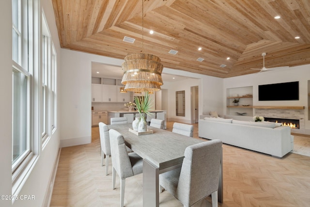 dining area featuring visible vents, built in features, recessed lighting, wooden ceiling, and a wealth of natural light