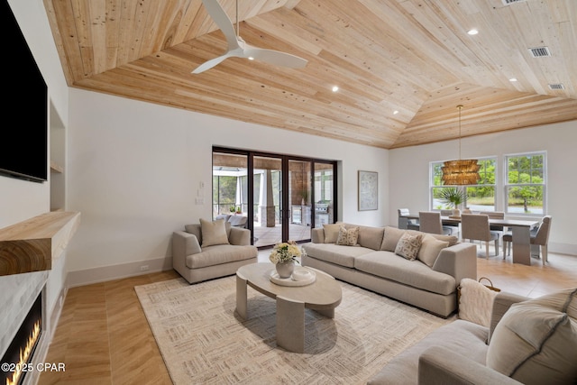 living room featuring wooden ceiling, baseboards, lofted ceiling, and a wealth of natural light