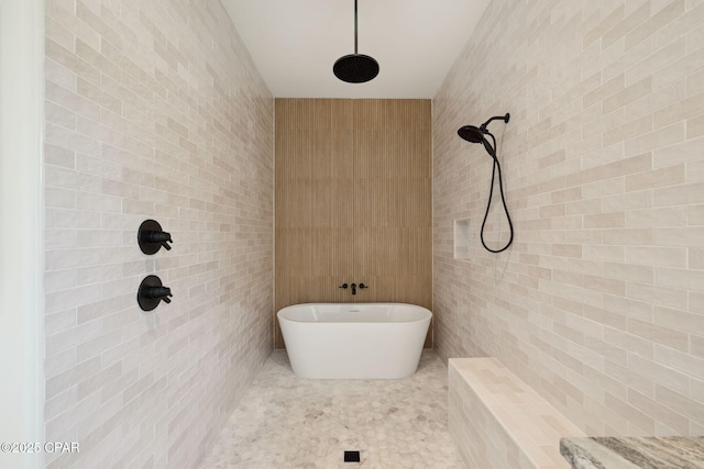 full bathroom featuring tile walls, a tile shower, and a soaking tub