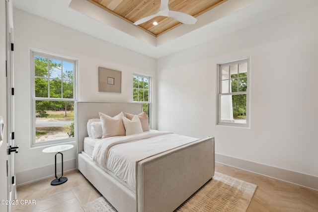 bedroom featuring a raised ceiling, baseboards, wood ceiling, and recessed lighting