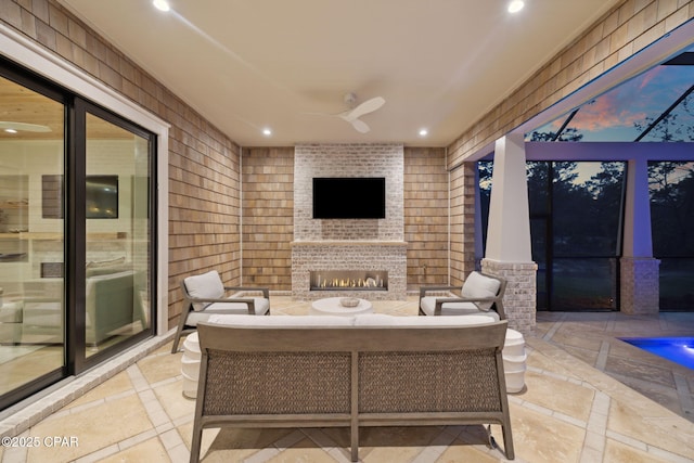 view of patio / terrace featuring an outdoor living space with a fireplace, ceiling fan, and glass enclosure
