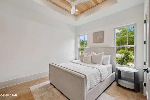 bedroom with a raised ceiling, baseboards, wood ceiling, and recessed lighting