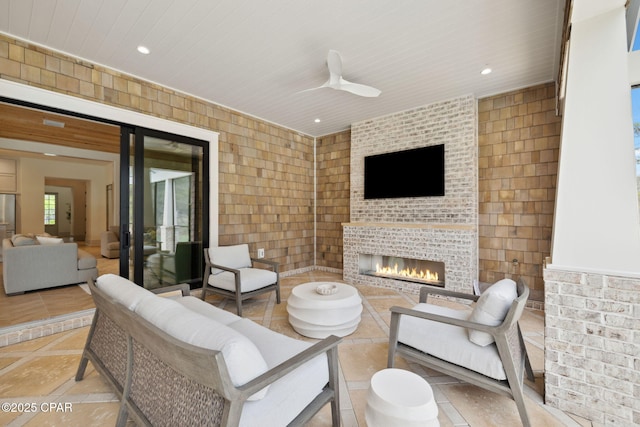 living area with a brick fireplace, recessed lighting, and tile walls