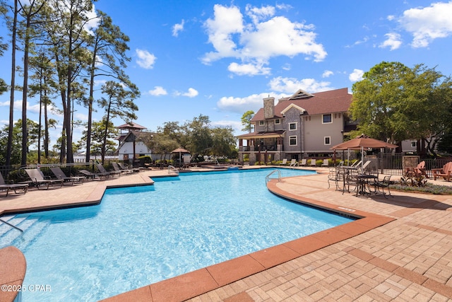 community pool featuring a patio area and fence
