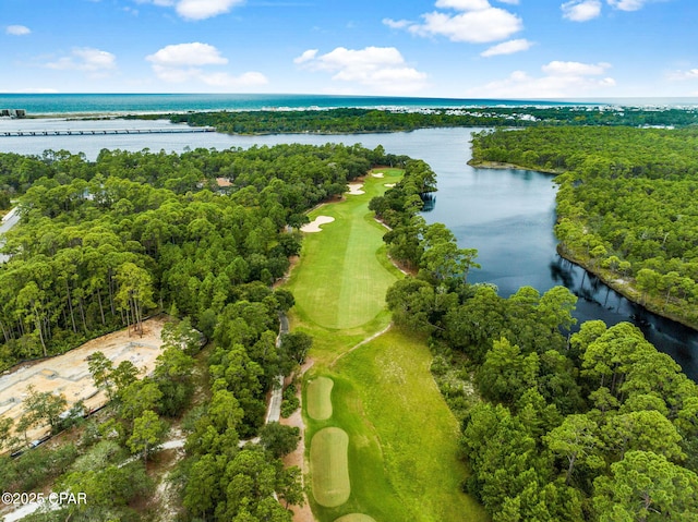 birds eye view of property with a water view and view of golf course