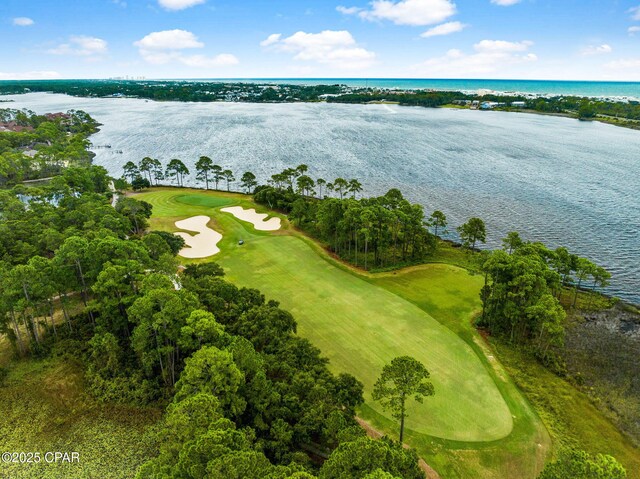 bird's eye view featuring view of golf course and a water view