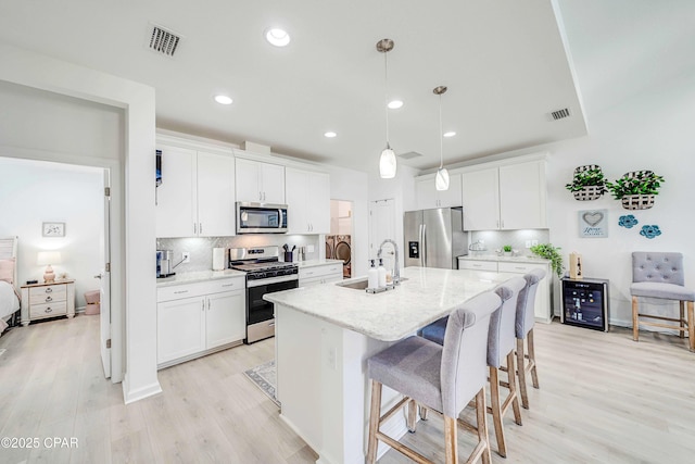 8738 Sand Dollar Dr, Panama City Beach, FL 32413 - kitchen featuring backsplash, stainless steel appliances, visible vents, and a sink