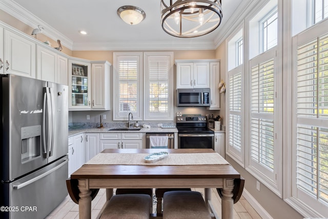 kitchen with white cabinetry, stainless steel appliances, a healthy amount of sunlight, and a sink