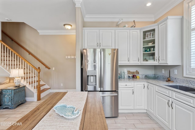kitchen featuring stainless steel fridge with ice dispenser, white cabinetry, glass insert cabinets, and ornamental molding