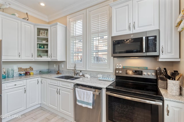 kitchen with white cabinetry, stainless steel appliances, and a sink