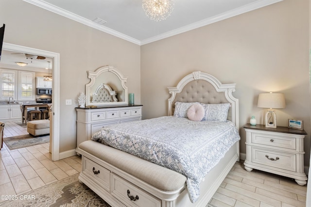 bedroom with a notable chandelier, wood tiled floor, baseboards, a sink, and crown molding